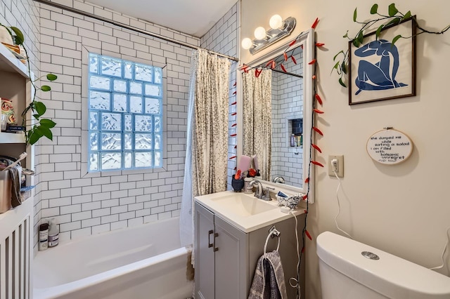 bathroom featuring toilet, vanity, and shower / bath combination with curtain