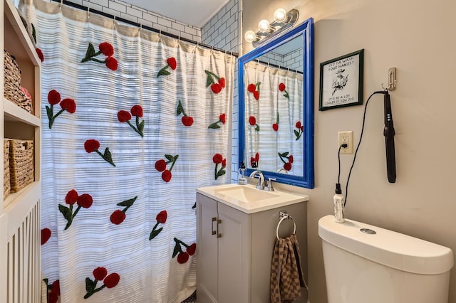 bathroom featuring vanity, toilet, and curtained shower