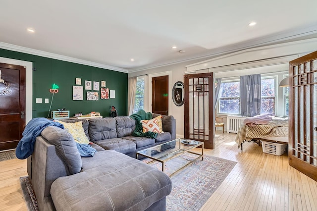 living area featuring radiator heating unit, crown molding, hardwood / wood-style floors, and recessed lighting