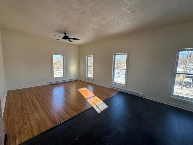 504 Buchanan St, Red Wing, MN 55066 - empty room with baseboard heating, ceiling fan, plenty of natural light, and a textured ceiling