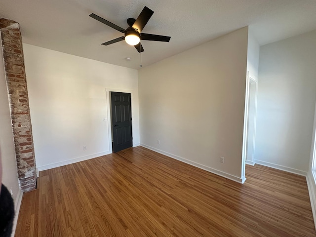 504 Buchanan St, Red Wing, MN 55066 - empty room with ceiling fan, wood finished floors, and baseboards