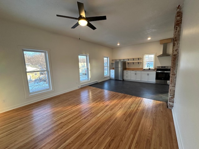 504 Buchanan St, Red Wing, MN 55066 - unfurnished living room featuring dark wood finished floors, a sink, a ceiling fan, baseboards, and baseboard heating