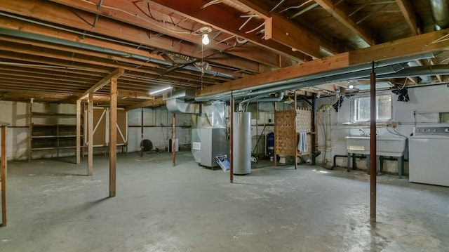 below grade area featuring washer / clothes dryer, gas water heater, heating unit, and a sink