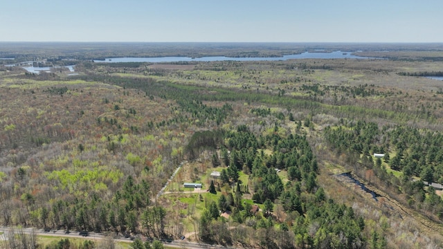 aerial overview of property's location with a heavily wooded area and a large body of water