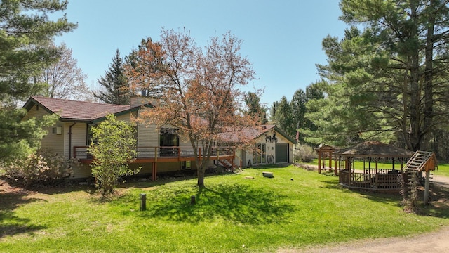 view of green lawn with a gazebo and a wooden deck