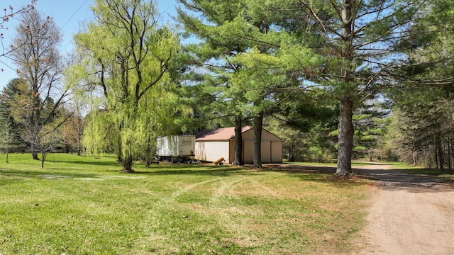 view of green lawn with an outbuilding