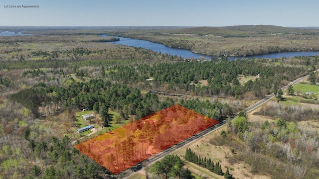 aerial overview of property's location featuring a nearby body of water, a heavily wooded area, and property boundaries highlighted