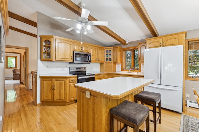 50 Lakeview Dr NW, Cokato, MN 55321 - kitchen with appliances with stainless steel finishes, glass insert cabinets, light countertops, light wood-type flooring, and tasteful backsplash