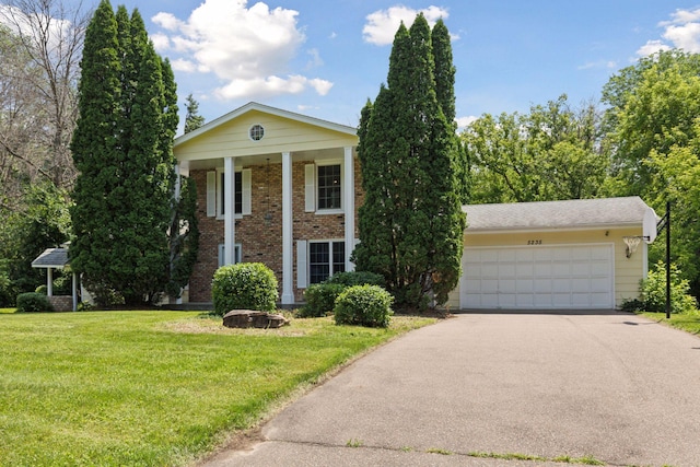 5235 139th St, Savage, MN 55378 - neoclassical home with a front yard, asphalt driveway, brick siding, and a garage