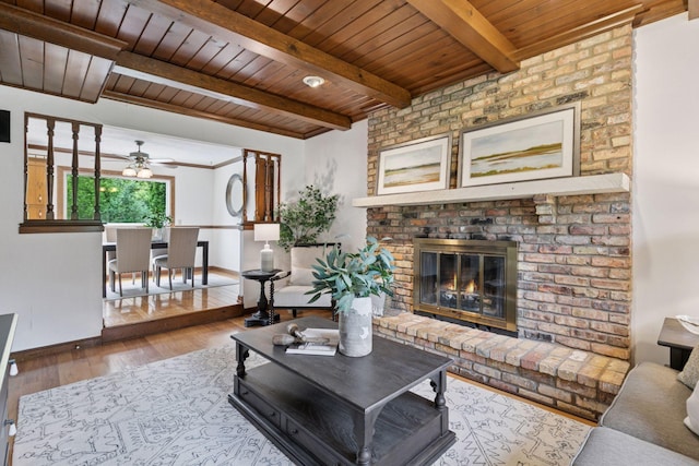 5235 139th St, Savage, MN 55378 - living area featuring a wood ceiling with exposed beams, wood finished floors, a ceiling fan, and a fireplace