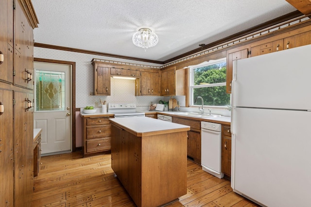 5235 139th St, Savage, MN 55378 - kitchen with white appliances, crown molding, light countertops, a chandelier, and light wood-style floors