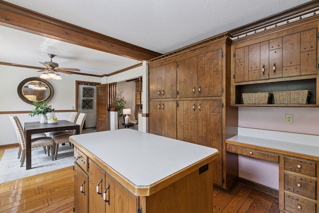 5235 139th St, Savage, MN 55378 - kitchen featuring light wood finished floors, light countertops, a ceiling fan, a center island, and a textured ceiling