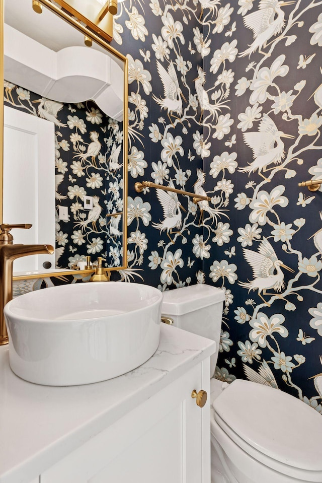 4201 Dupont Ave S, Minneapolis, MN 55409 - half bathroom featuring wallpapered walls, toilet, and vanity