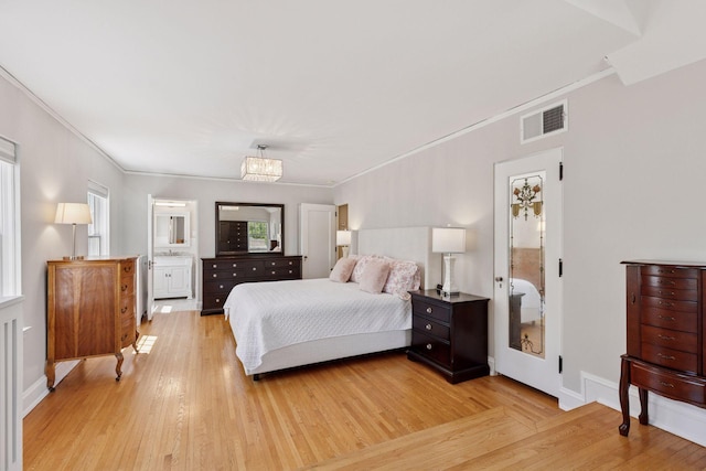 4201 Dupont Ave S, Minneapolis, MN 55409 - bedroom with crown molding, light wood finished floors, a chandelier, baseboards, and connected bathroom