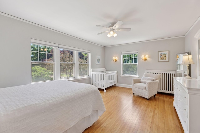 4201 Dupont Ave S, Minneapolis, MN 55409 - bedroom featuring light wood-type flooring, ornamental molding, ceiling fan, and baseboards