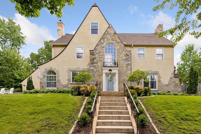 4201 Dupont Ave S, Minneapolis, MN 55409 - english style home with a chimney, stone siding, stucco siding, and a front yard