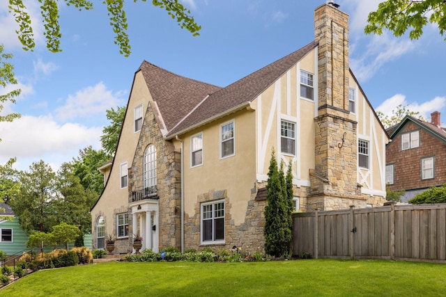 4201 Dupont Ave S, Minneapolis, MN 55409 - tudor house featuring stone siding, stucco siding, a chimney, and roof with shingles