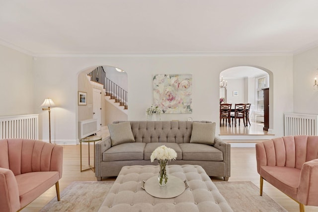 4201 Dupont Ave S, Minneapolis, MN 55409 - living area featuring arched walkways, crown molding, light wood-style flooring, and baseboards