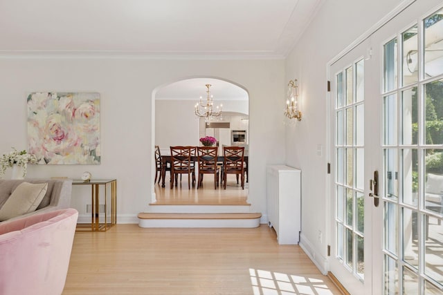 4201 Dupont Ave S, Minneapolis, MN 55409 - dining area with arched walkways, wood finished floors, a chandelier, ornamental molding, and baseboards