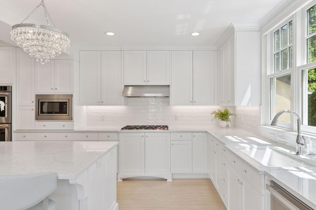 4201 Dupont Ave S, Minneapolis, MN 55409 - kitchen with stainless steel appliances, under cabinet range hood, a sink, healthy amount of natural light, and recessed lighting