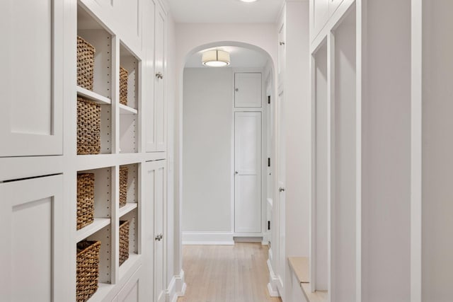 4201 Dupont Ave S, Minneapolis, MN 55409 - hallway with arched walkways, light wood-style flooring, and baseboards