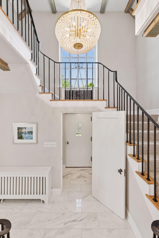 4201 Dupont Ave S, Minneapolis, MN 55409 - staircase featuring a chandelier, a towering ceiling, baseboards, marble look tiles, and healthy amount of natural light