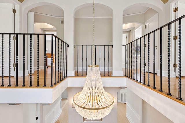 4201 Dupont Ave S, Minneapolis, MN 55409 - staircase featuring a chandelier, wood finished floors, and baseboards