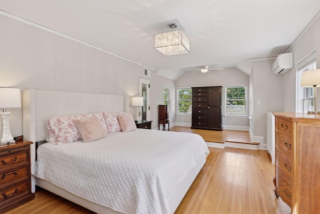 4201 Dupont Ave S, Minneapolis, MN 55409 - bedroom featuring a wall mounted AC, light wood-type flooring, vaulted ceiling, and baseboards