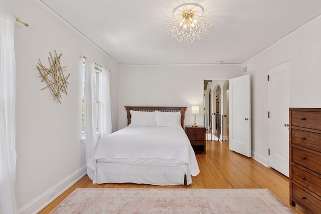 4201 Dupont Ave S, Minneapolis, MN 55409 - bedroom featuring wood finished floors, a chandelier, and baseboards