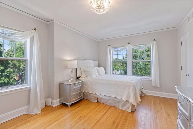 4201 Dupont Ave S, Minneapolis, MN 55409 - bedroom with light wood finished floors, baseboards, and ornamental molding
