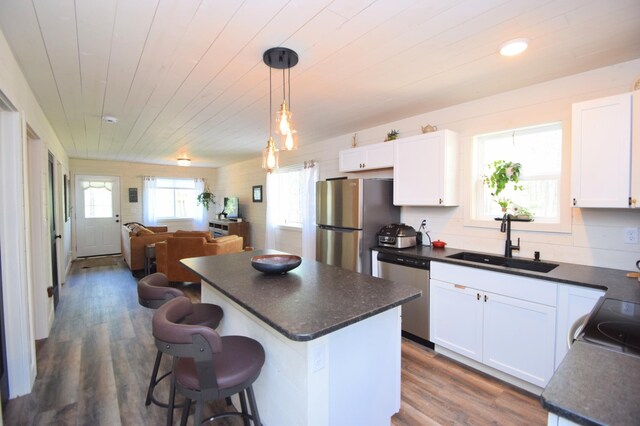 28607 Great Bear Path Way, Danbury, WI 54830 - kitchen with a sink, appliances with stainless steel finishes, dark countertops, white cabinets, and wooden ceiling