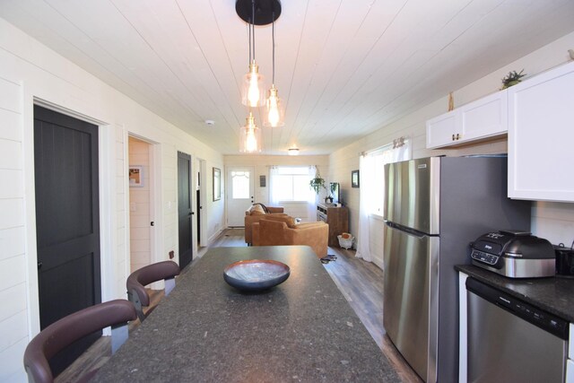28607 Great Bear Path Way, Danbury, WI 54830 - kitchen with dishwasher, white cabinets, hanging light fixtures, wood ceiling, and open floor plan