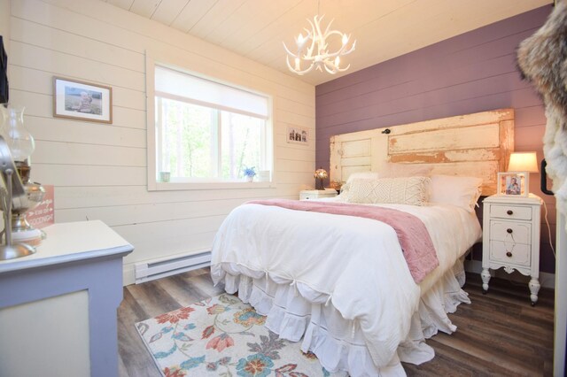 28607 Great Bear Path Way, Danbury, WI 54830 - bedroom featuring a baseboard heating unit, wooden walls, a chandelier, and wood finished floors