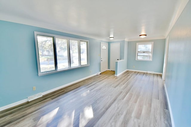 empty room with baseboards and wood finished floors