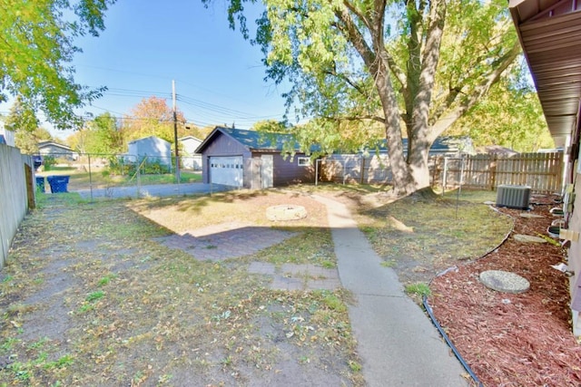 fenced backyard featuring a garage and central air condition unit