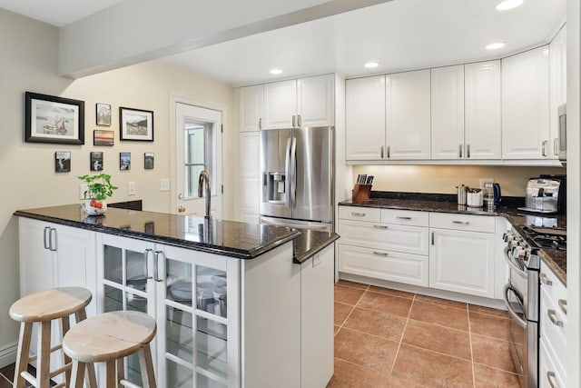 166 Windsor Ln, New Brighton, MN 55112 - kitchen featuring appliances with stainless steel finishes, white cabinetry, recessed lighting, and dark stone countertops