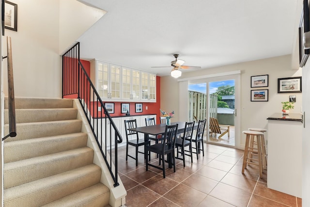 166 Windsor Ln, New Brighton, MN 55112 - dining space with ceiling fan, dark tile patterned floors, and stairway