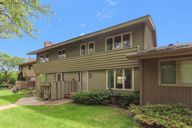 166 Windsor Ln, New Brighton, MN 55112 - back of property with a chimney and a lawn