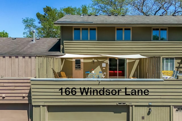 166 Windsor Ln, New Brighton, MN 55112 - back of property featuring an attached garage