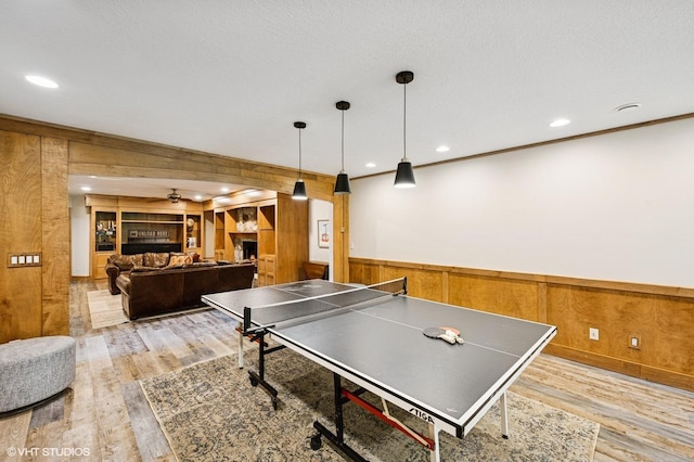 820 Vineland Ct, Chanhassen, MN 55317 - playroom with wooden walls, wood finished floors, a wainscoted wall, recessed lighting, and ceiling fan