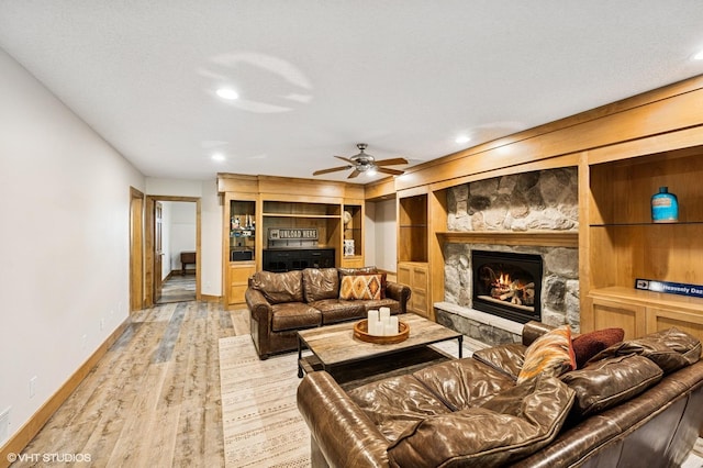 820 Vineland Ct, Chanhassen, MN 55317 - living area with baseboards, wood finished floors, a stone fireplace, ceiling fan, and recessed lighting