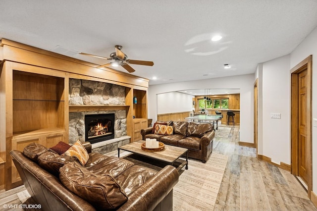 820 Vineland Ct, Chanhassen, MN 55317 - living room with a stone fireplace, wood finished floors, and ceiling fan
