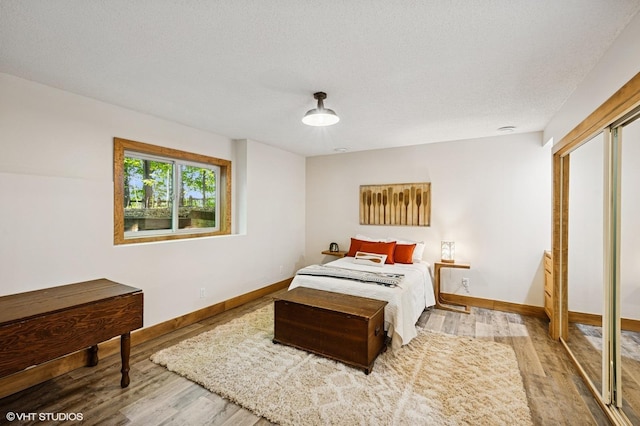 820 Vineland Ct, Chanhassen, MN 55317 - bedroom with wood finished floors, baseboards, and a textured ceiling