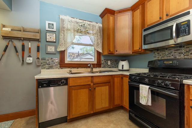 kitchen with stainless steel appliances, a sink, light countertops, brown cabinets, and tasteful backsplash