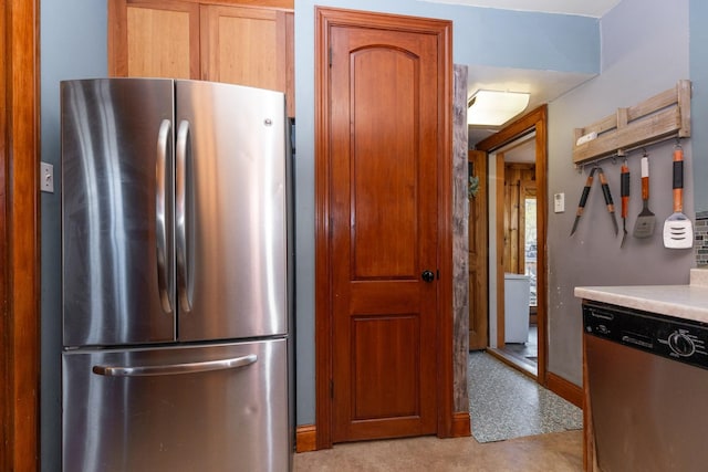 kitchen with stainless steel appliances, light countertops, and brown cabinetry