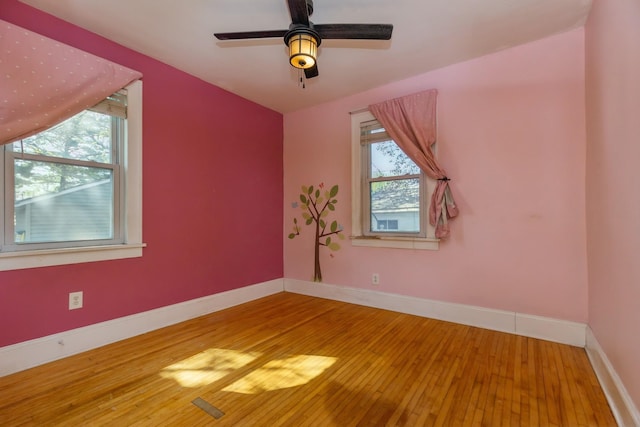 additional living space featuring wood-type flooring, baseboards, and ceiling fan