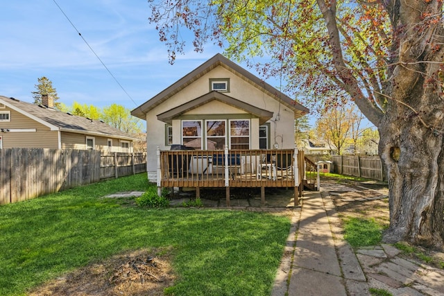 rear view of house featuring a deck and stucco siding