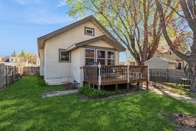 back of house featuring a deck and stucco siding