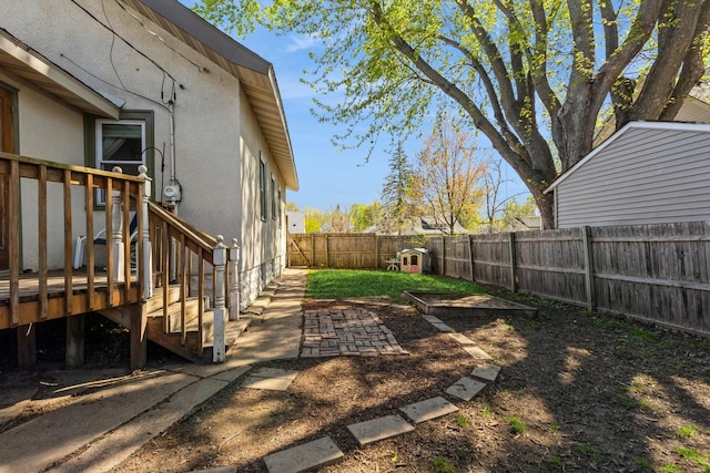 fenced backyard featuring a deck