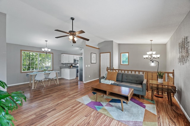 10751 Kumquat St NW, Coon Rapids, MN 55448 - living room with a chandelier, wood finished floors, ceiling fan, lofted ceiling, and baseboards